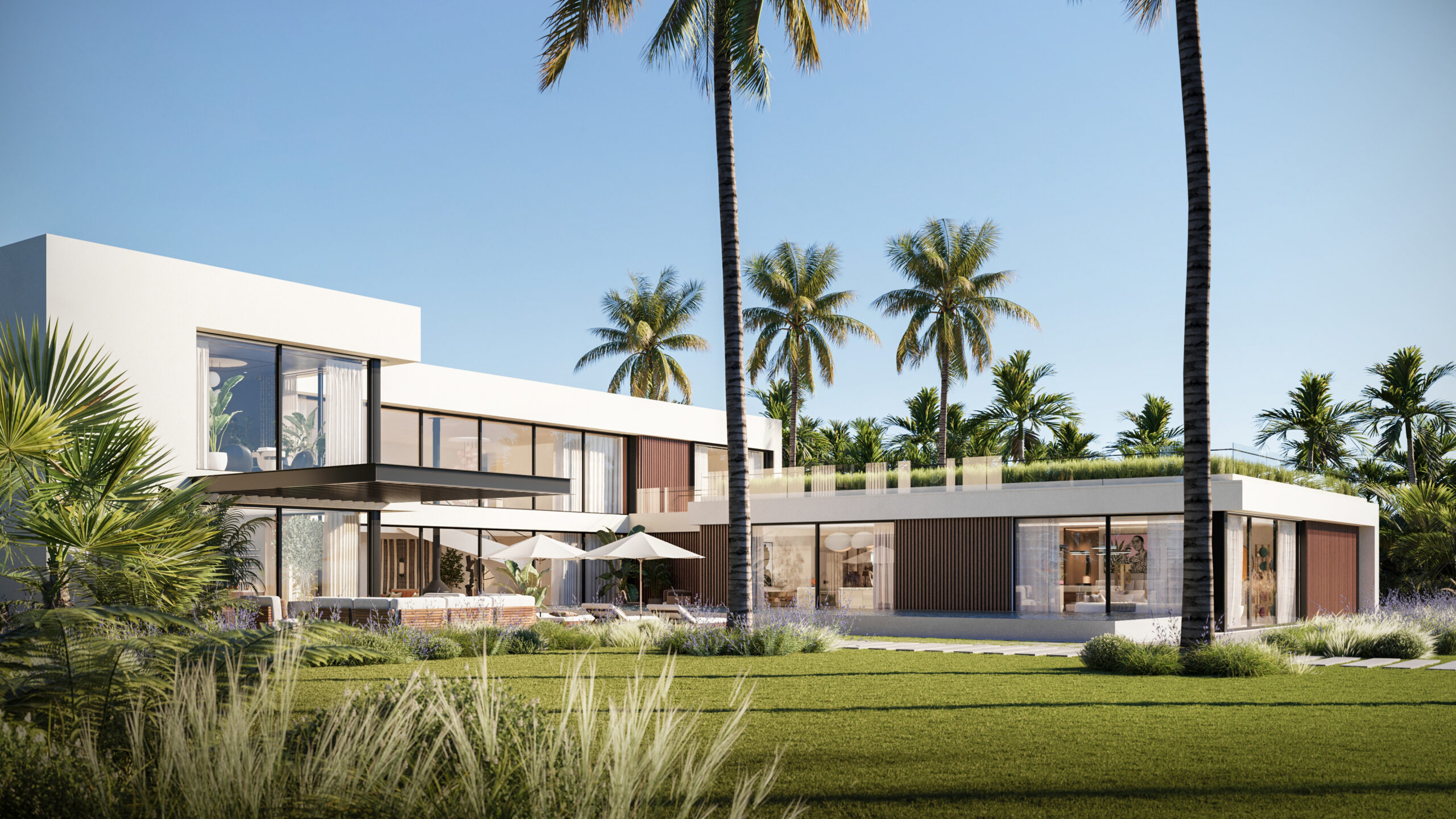 The Iconic House 2023, envisioned by a leading architectural design studio in Lagos, led by Tosin Oshinowo, stands proudly amidst a lush landscape. This modern abode is characterized by a harmonious blend of natural wood elements, expansive glass windows, and minimalist white surfaces. The house features several outdoor living spaces, including a shaded patio area with elegant furniture, perfect for relaxation. Tall palm trees add to the tropical ambiance, enhancing the property's connection to its natural environment.
