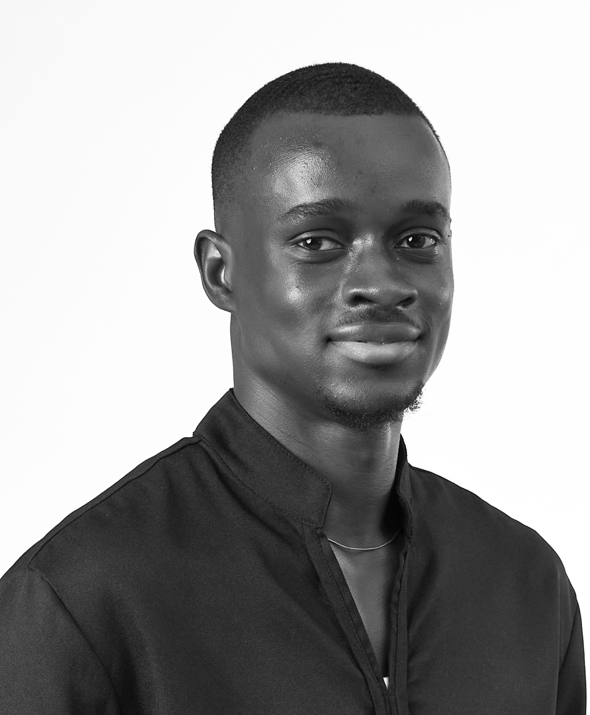 Black and white portrait of OLABODE TOYO as part of the Oshinowo Studio team picture