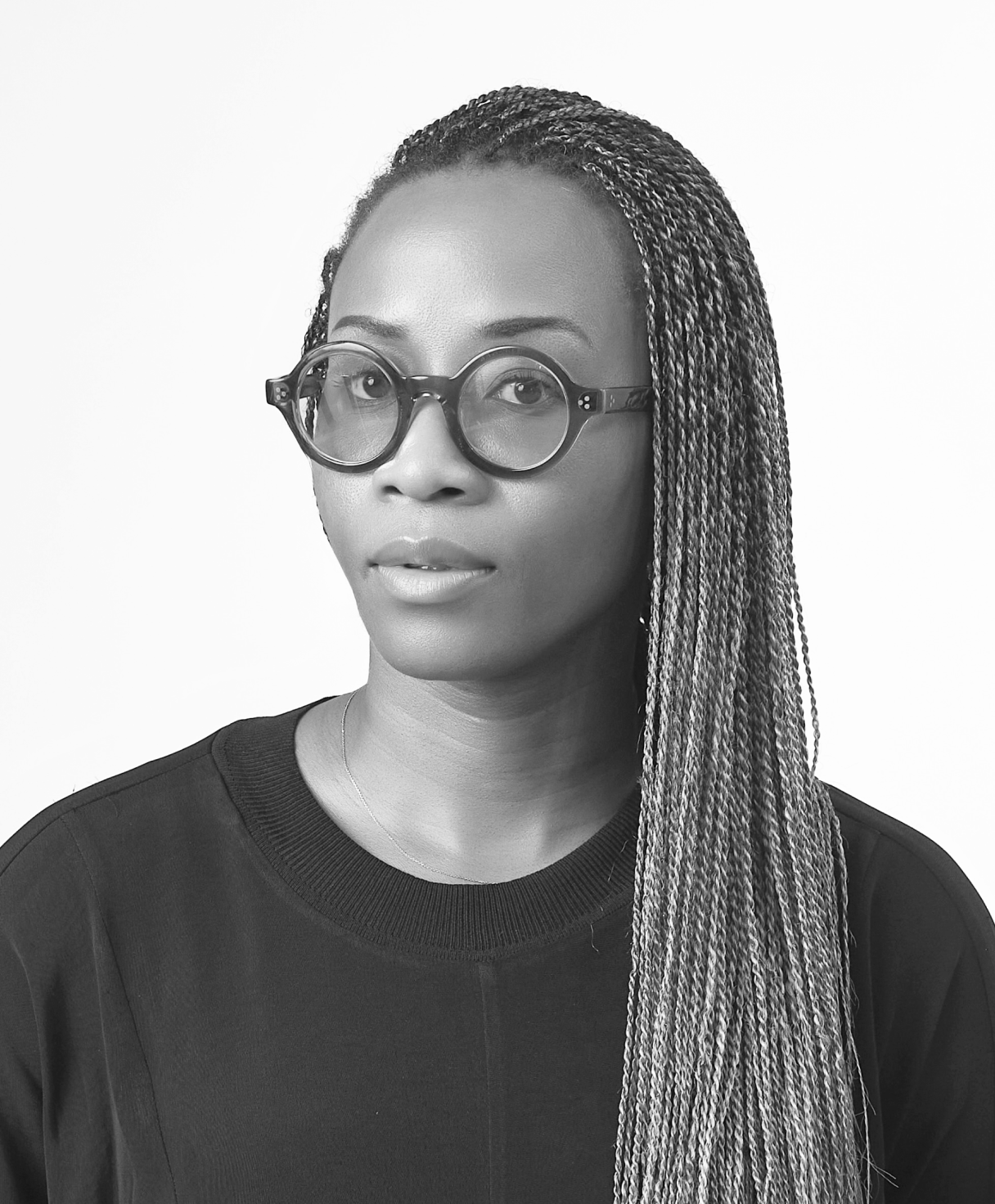 Black and white portrait of Tosin Oshinowo as part of the Oshinowo Studio team picture